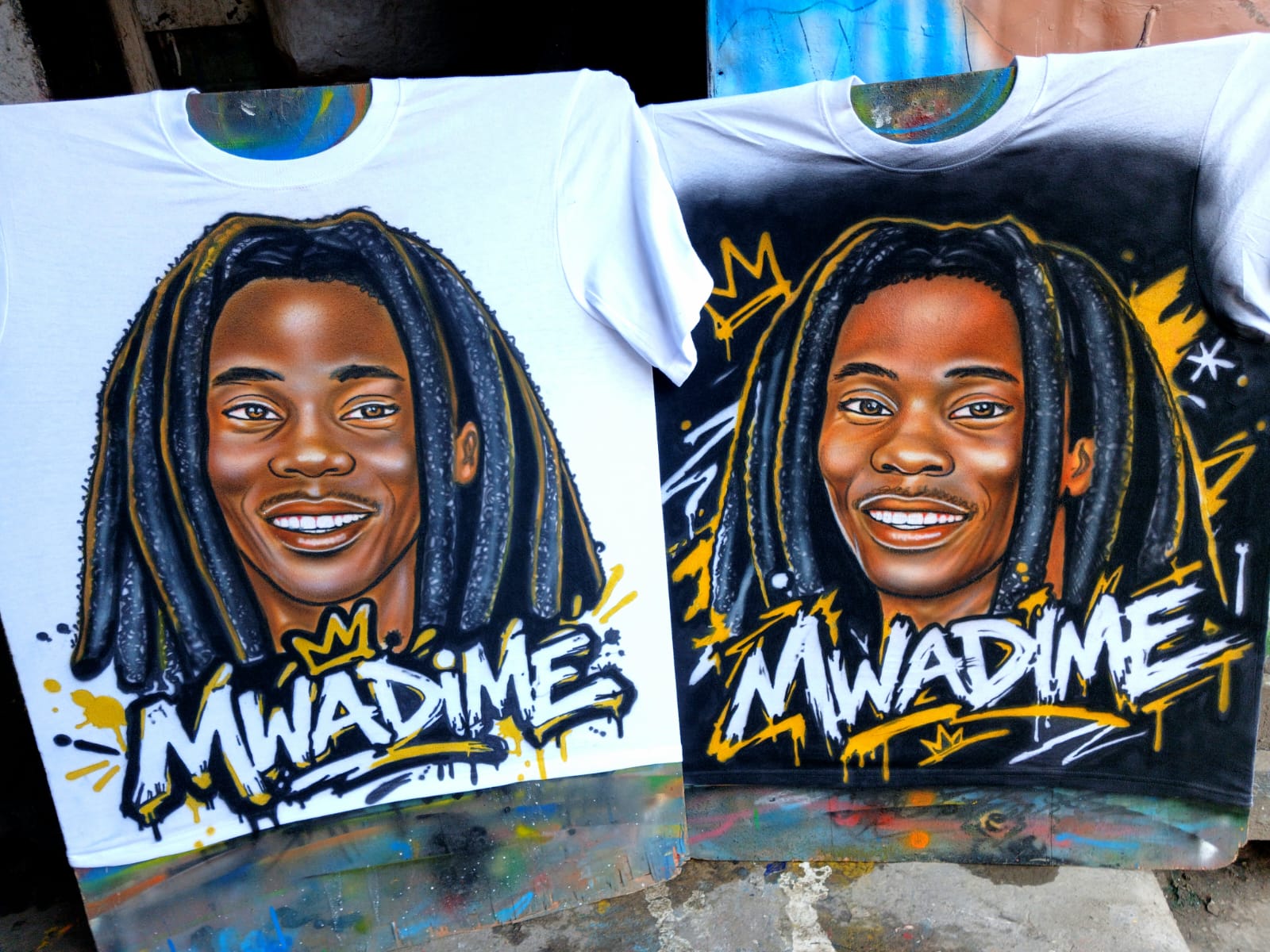 Mwadime Portrait Tee — Airbrushed portrait with graffiti 'MWADIME' lettering — white and black versions side by side. Custom Junkies Africa custom tees portfolio piece.